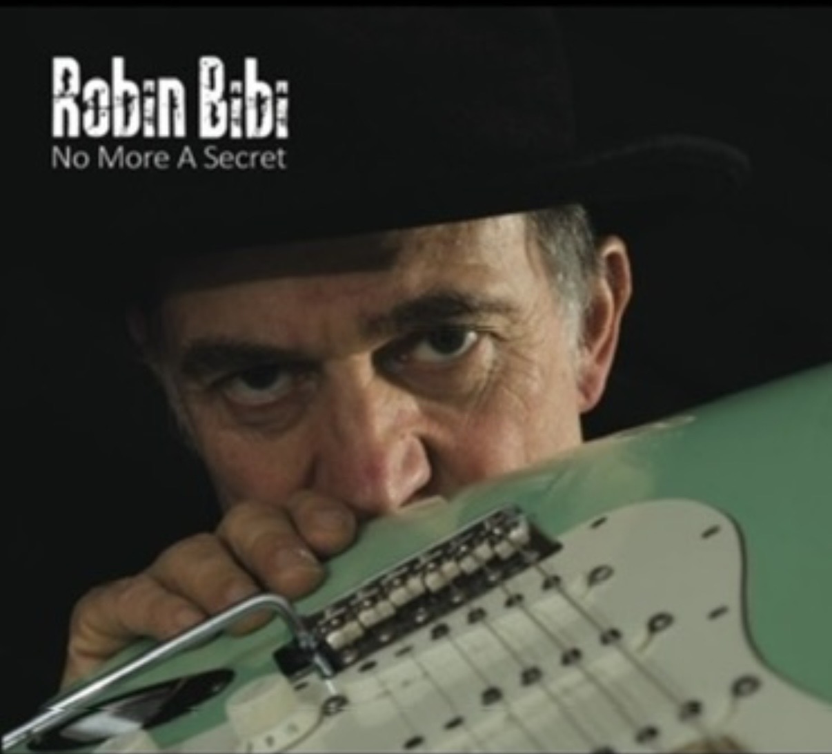 Robin Bibi peering over the body of a seafoam-green Stratocaster — artwork from the "No More A Secret" album